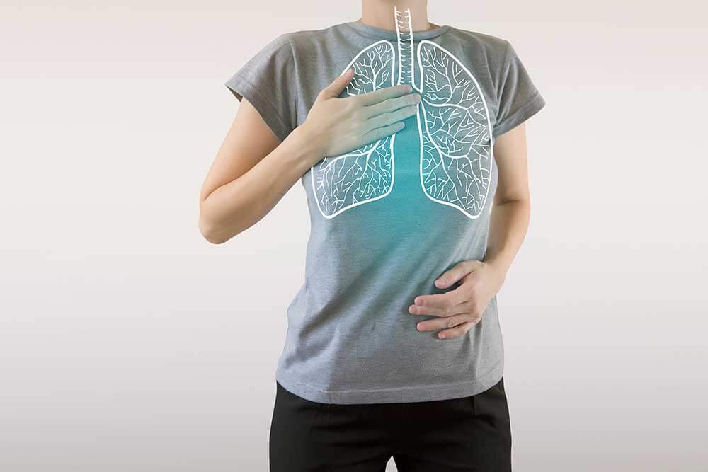 a person with their hand on their chest wearing a shirt with lungs drawing