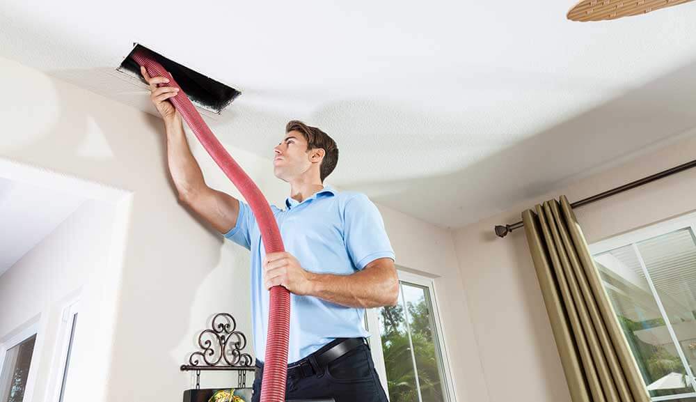 man cleaning air ducts